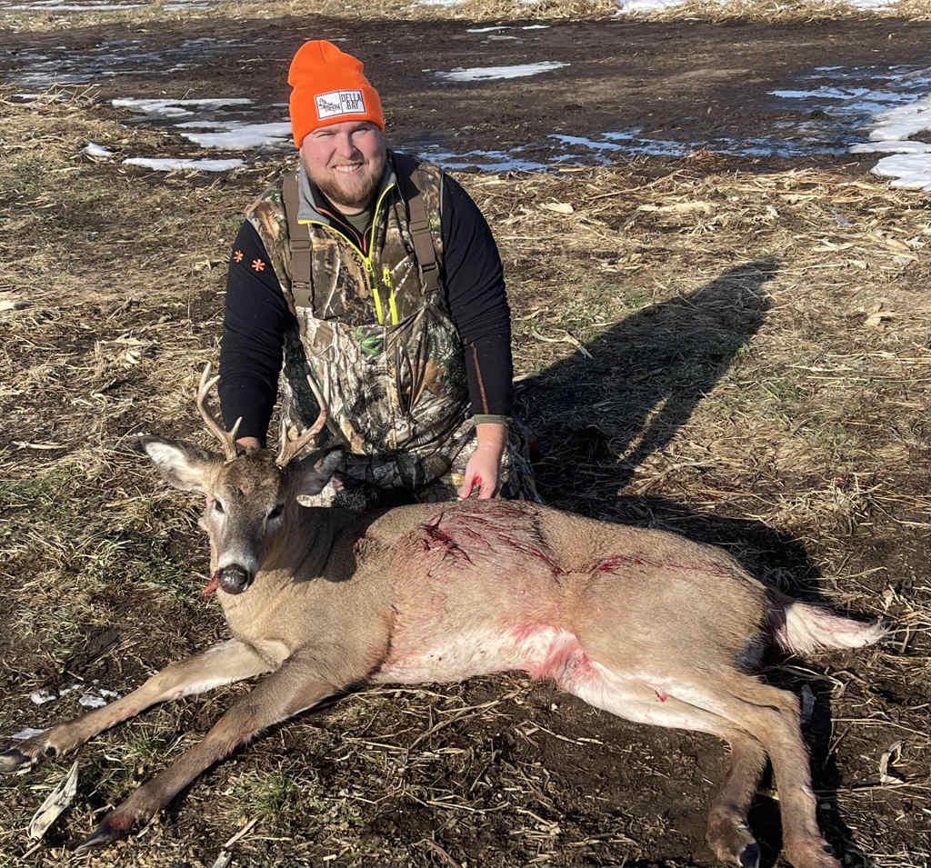 hunter Cole Karsky sits behind the whitetail he caught