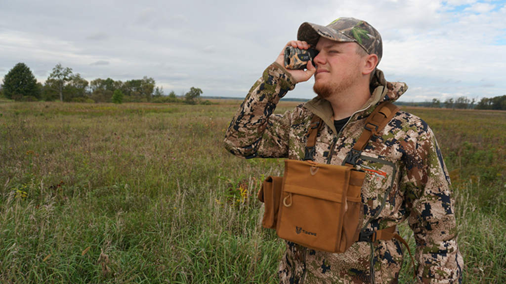 the hunter use the rangefinder to search for pests