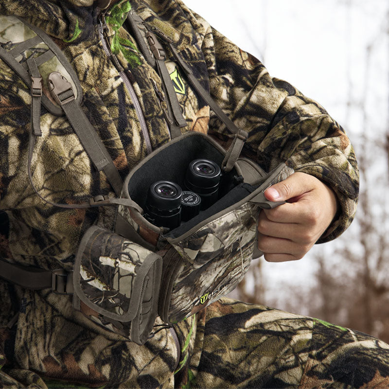 Whitetail bowhunter wearing quiet hunting clothes during a long autumn tree-stand sit