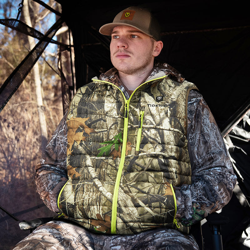 a man hunter with heated vest sits in the hunting blind