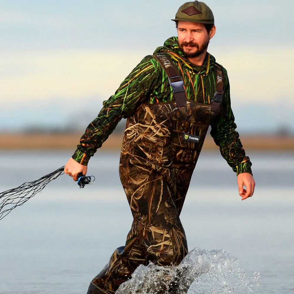 A man with waders on walks in the river