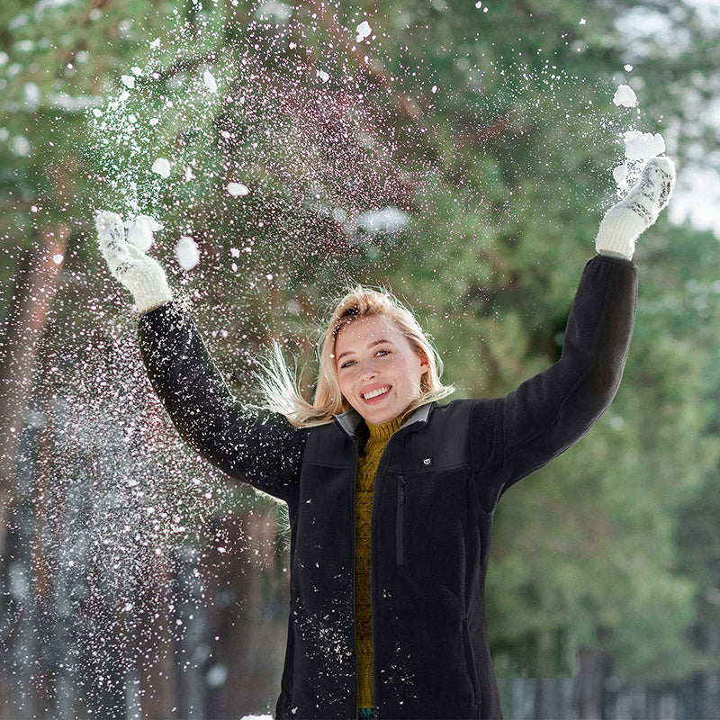 Woman throwing snow in the air wearing TIDEWE Women’s Heated Jacket Fleece with Battery Pack for hunting.
