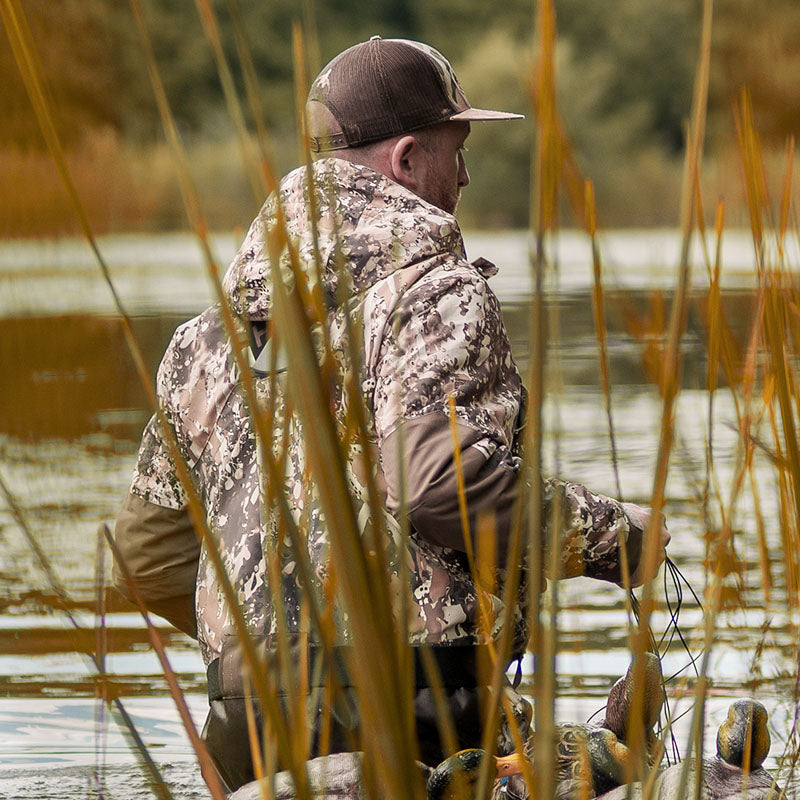 A duck hunter turns his back on you