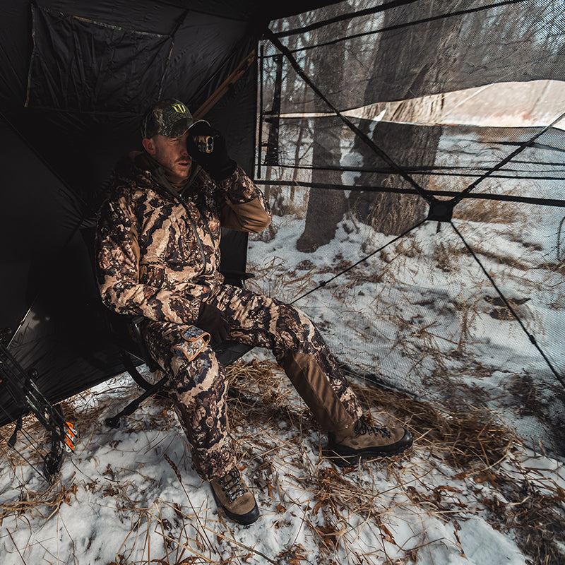 A hunter observes the field from the blind