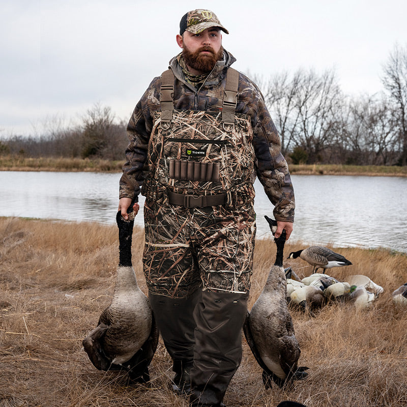 A man wearing a wader with ducks on his hands