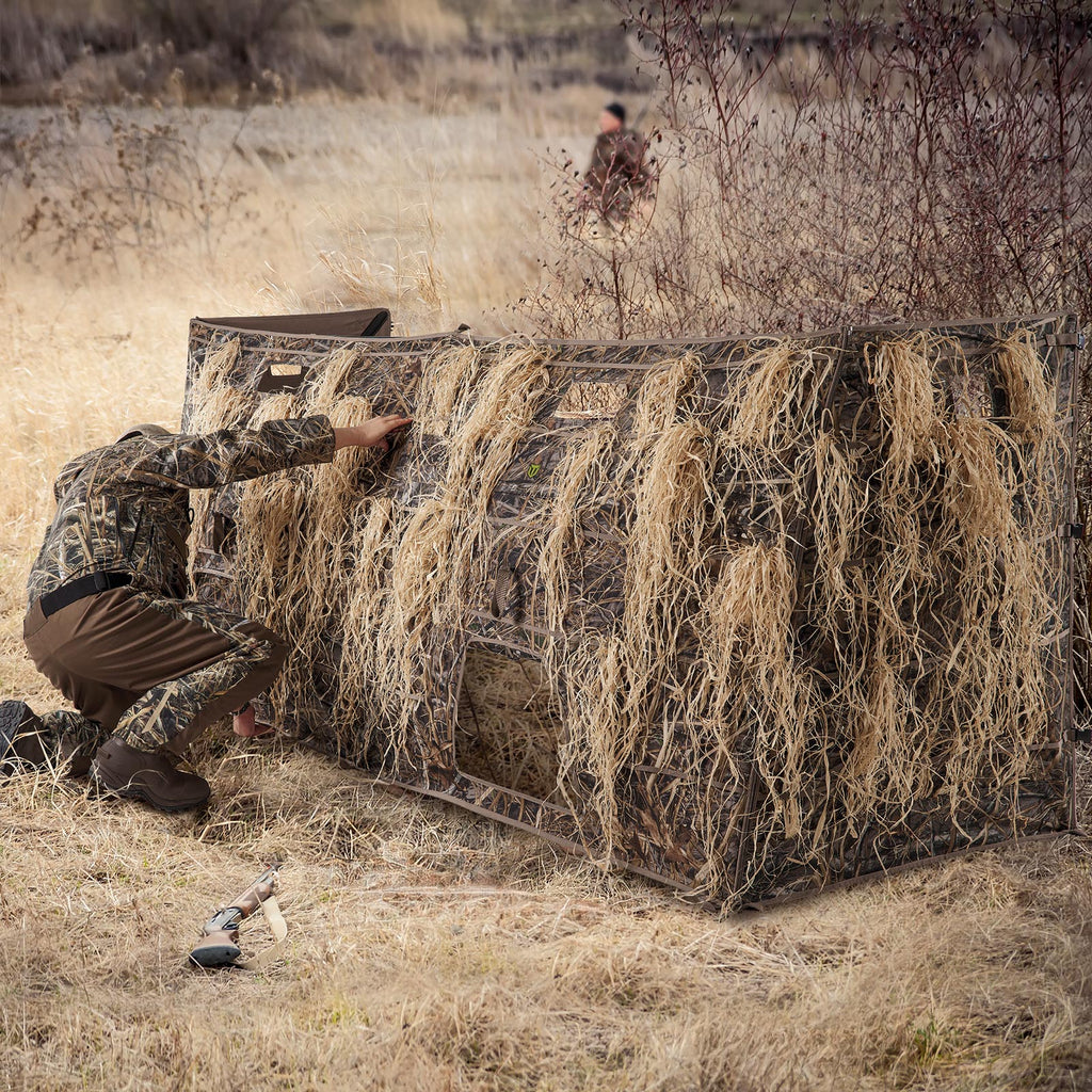 the hunter hides the Tidewe Panel Blind by dry grass